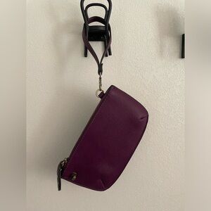 Grape-colored wristlet by Joy.